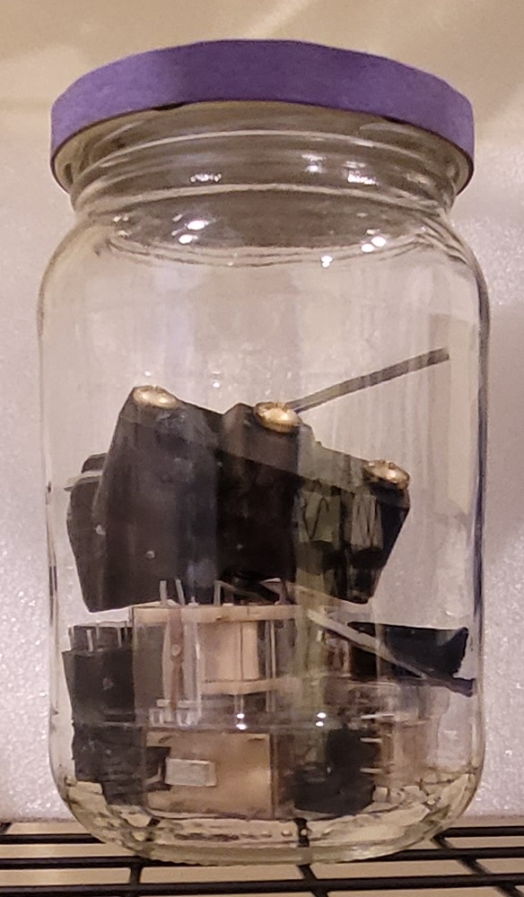 Glass jar containing 
contact switches and relays